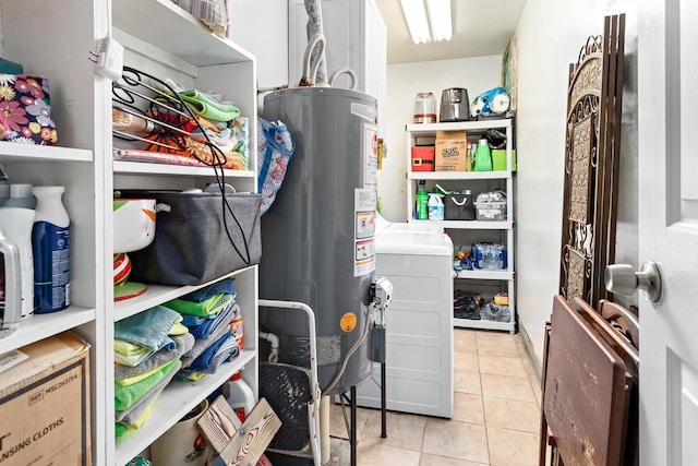 970 Evergreen Ln, Beaumont, TX 77706 - washroom featuring gas water heater, light tile patterned floors, and washer and clothes dryer