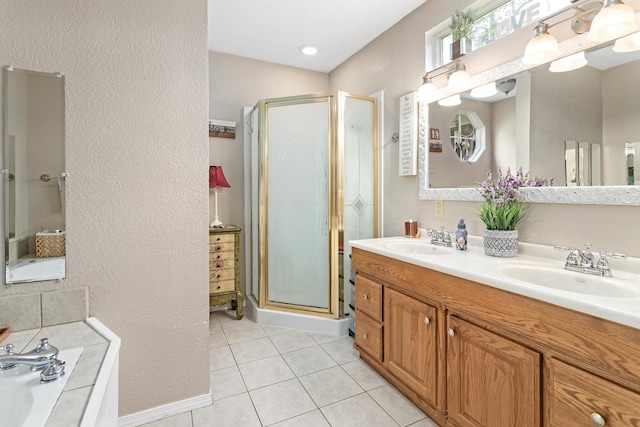 970 Evergreen Ln, Beaumont, TX 77706 - full bath featuring a shower stall, double vanity, tile patterned floors, and a bath