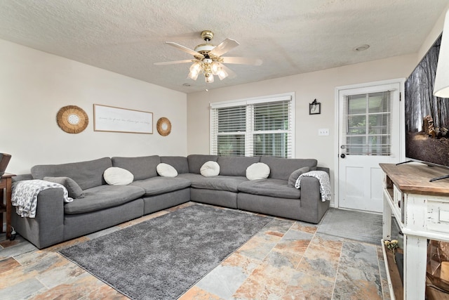 970 Evergreen Ln, Beaumont, TX 77706 - living room with stone tile flooring, ceiling fan, and a textured ceiling