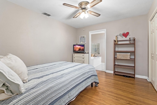 970 Evergreen Ln, Beaumont, TX 77706 - bedroom featuring light wood-style flooring, baseboards, a closet, ensuite bath, and a ceiling fan