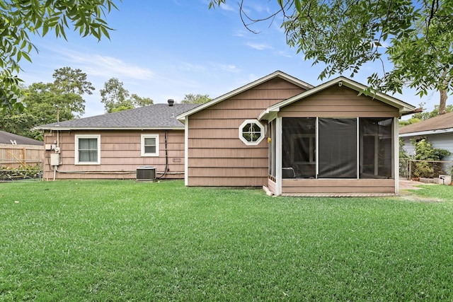 970 Evergreen Ln, Beaumont, TX 77706 - rear view of house with central AC unit, a sunroom, and a shingled roof