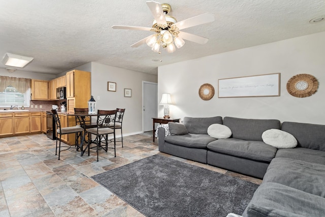 970 Evergreen Ln, Beaumont, TX 77706 - living area featuring light stone finish flooring, ceiling fan, and a textured ceiling