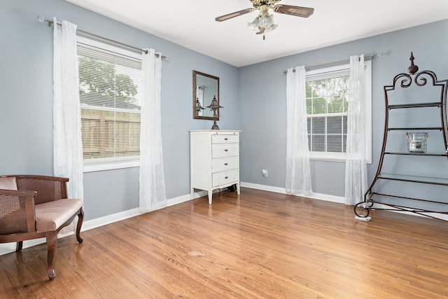970 Evergreen Ln, Beaumont, TX 77706 - sitting room featuring healthy amount of natural light, wood finished floors, a ceiling fan, and baseboards