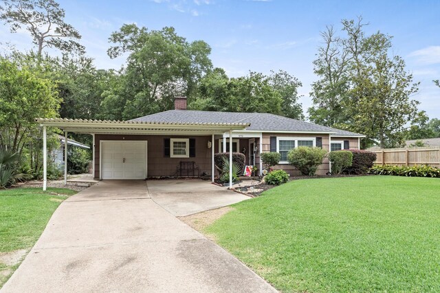 970 Evergreen Ln, Beaumont, TX 77706 - ranch-style home featuring a garage, a chimney, driveway, and a carport