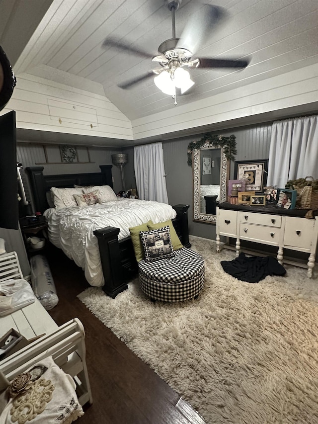 bedroom with vaulted ceiling, ceiling fan, and dark wood-type flooring