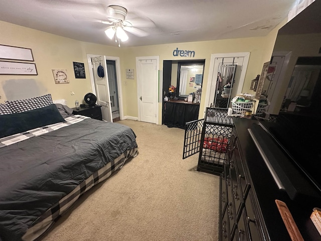 bedroom with ceiling fan and light colored carpet