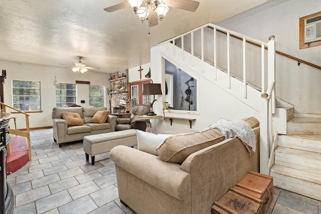 tiled living room featuring a textured ceiling, an AC wall unit, and ceiling fan