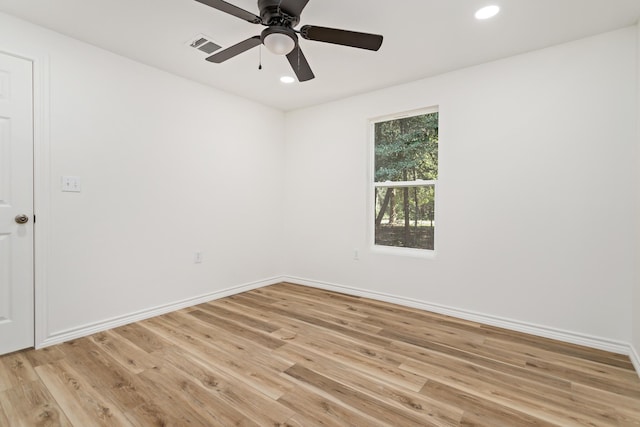 empty room with ceiling fan and light hardwood / wood-style flooring