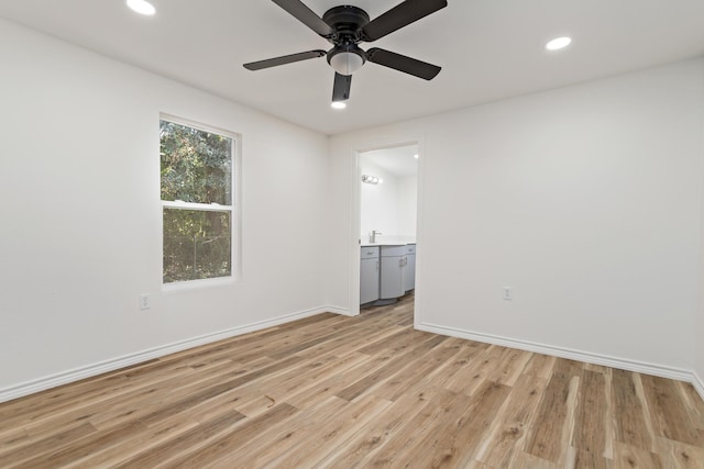 unfurnished room featuring ceiling fan and light hardwood / wood-style flooring