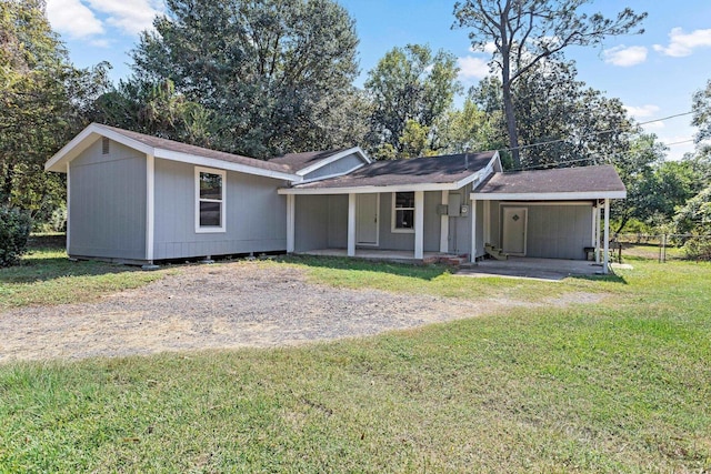 ranch-style house featuring a front lawn and covered porch