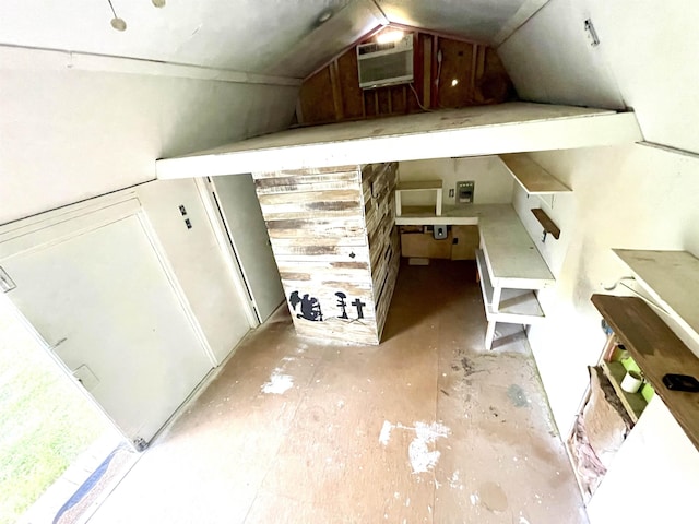 bonus room with an AC wall unit and vaulted ceiling