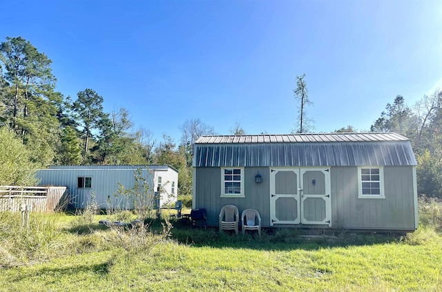 view of outbuilding with a yard