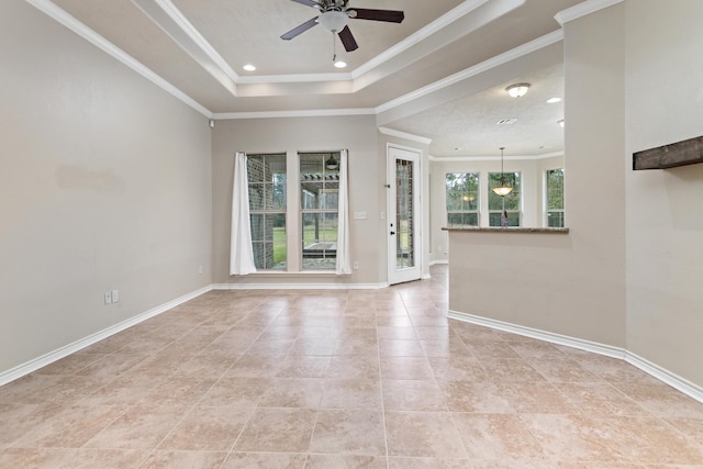 empty room featuring ceiling fan, crown molding, and a tray ceiling