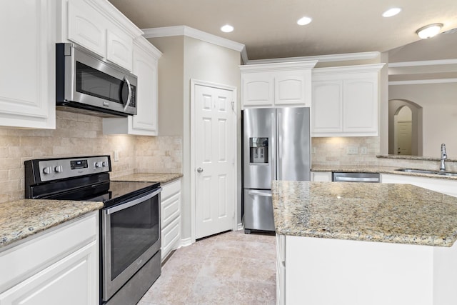 kitchen featuring white cabinets, light stone counters, sink, and stainless steel appliances