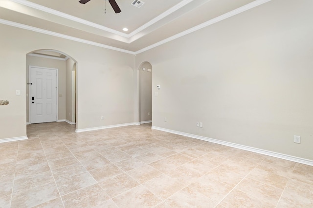 spare room featuring ceiling fan, a raised ceiling, and crown molding