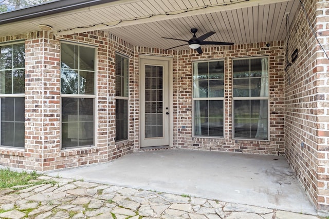 property entrance with a patio and ceiling fan