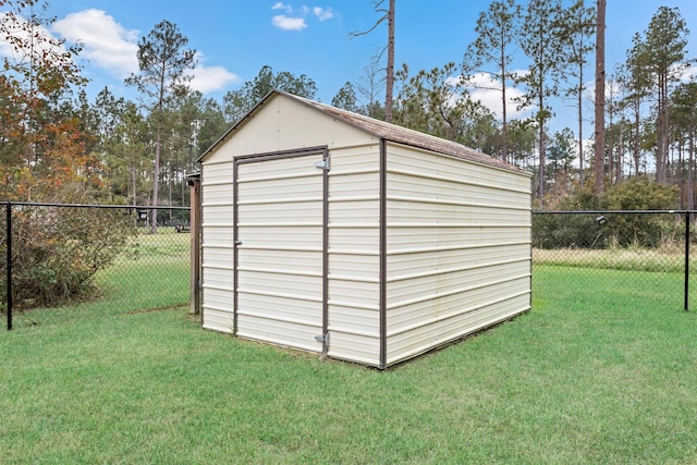 view of outbuilding with a yard