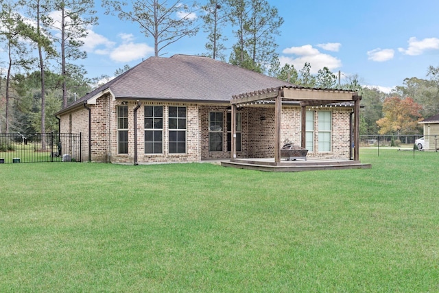 back of house featuring a pergola and a lawn