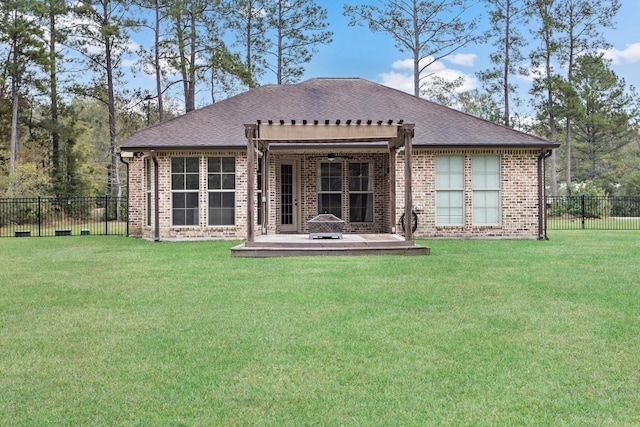 rear view of house featuring a pergola, a patio area, and a yard