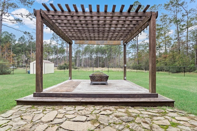 view of patio / terrace with a fire pit, a deck, a pergola, and a shed