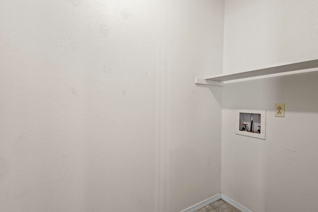 laundry room with baseboards, laundry area, and washer hookup