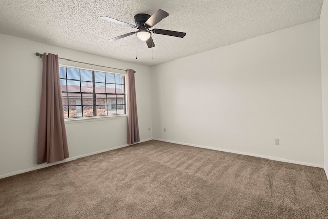 spare room featuring a ceiling fan, baseboards, carpet floors, and a textured ceiling