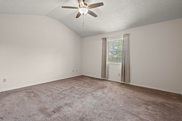 carpeted spare room with lofted ceiling, a ceiling fan, baseboards, and a textured ceiling