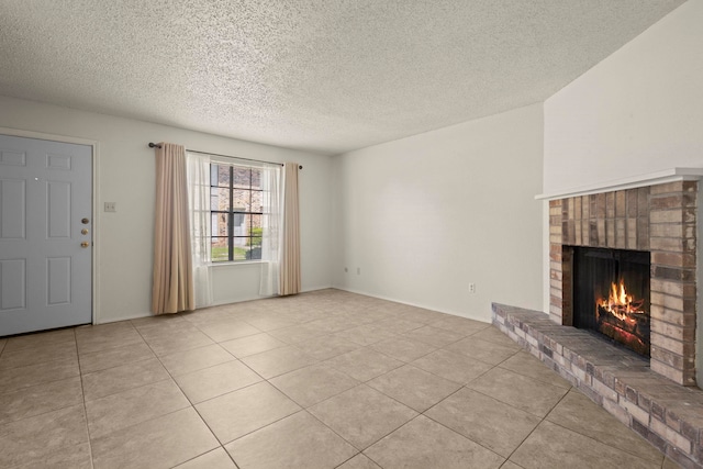 unfurnished living room featuring a fireplace, a textured ceiling, and light tile patterned flooring