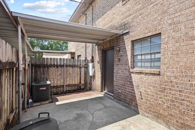view of patio / terrace featuring central air condition unit and fence