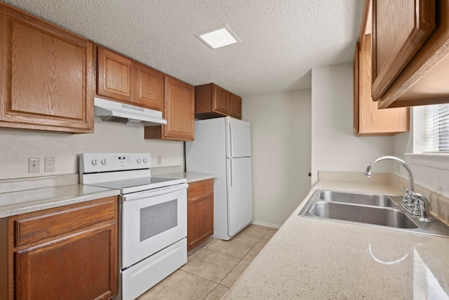 kitchen with a sink, brown cabinets, white appliances, light tile patterned floors, and under cabinet range hood