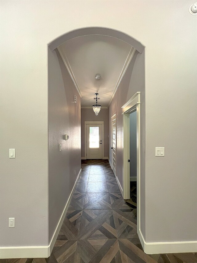 10675 Vinson St, Beaumont, TX 77713 - doorway with crown molding, baseboards, and arched walkways