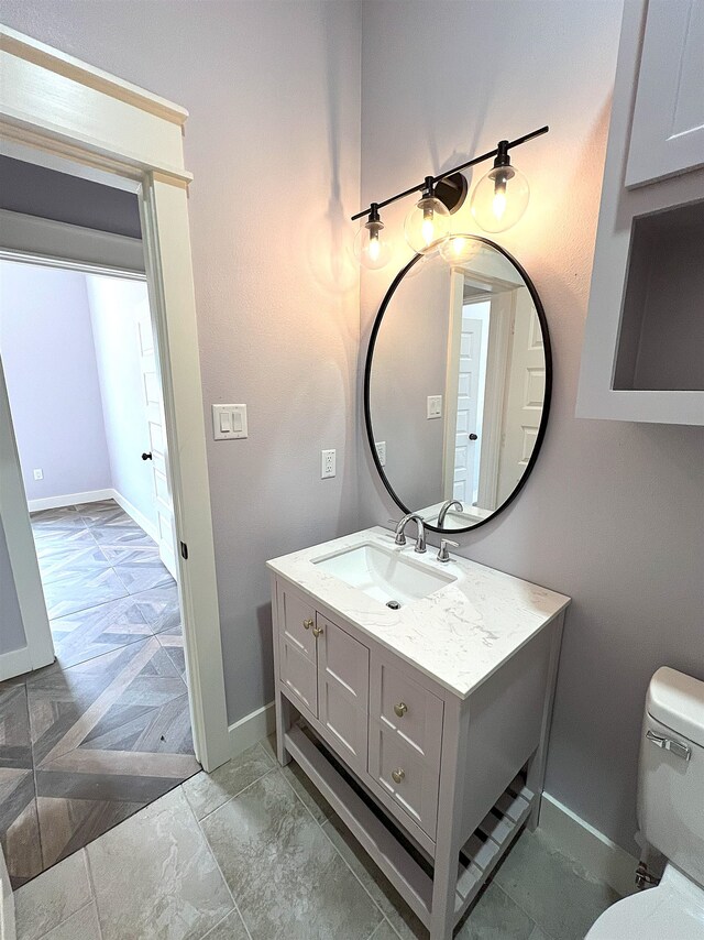 10675 Vinson St, Beaumont, TX 77713 - half bathroom with toilet, vanity, and baseboards