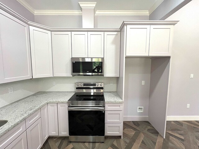 10675 Vinson St, Beaumont, TX 77713 - kitchen featuring appliances with stainless steel finishes, crown molding, tasteful backsplash, light stone counters, and baseboards