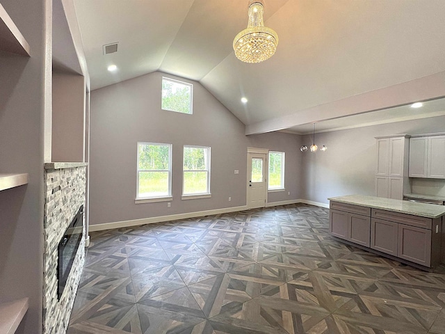 10675 Vinson St, Beaumont, TX 77713 - unfurnished living room with a chandelier, plenty of natural light, baseboards, high vaulted ceiling, and recessed lighting