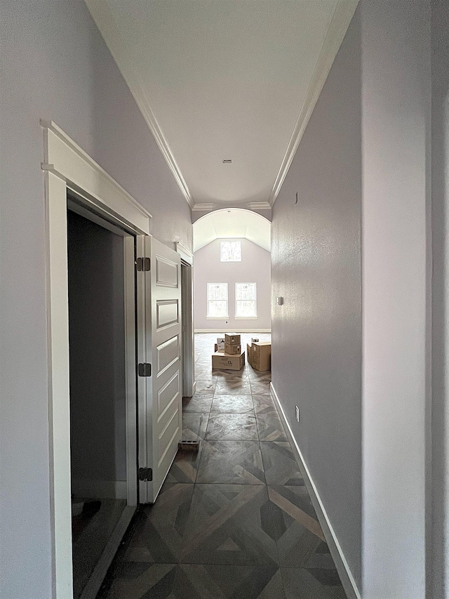 corridor with baseboards and ornamental molding