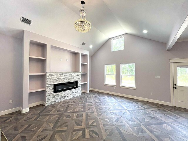10675 Vinson St, Beaumont, TX 77713 - unfurnished living room featuring plenty of natural light, baseboards, lofted ceiling, built in features, and a fireplace