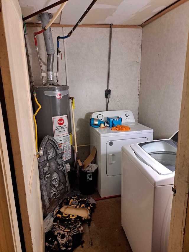 laundry area with washing machine and clothes dryer and gas water heater