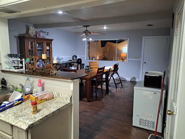 kitchen with beam ceiling, ceiling fan, sink, and dark hardwood / wood-style floors