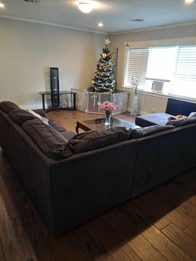 living room with crown molding, hardwood / wood-style floors, cooling unit, and a textured ceiling