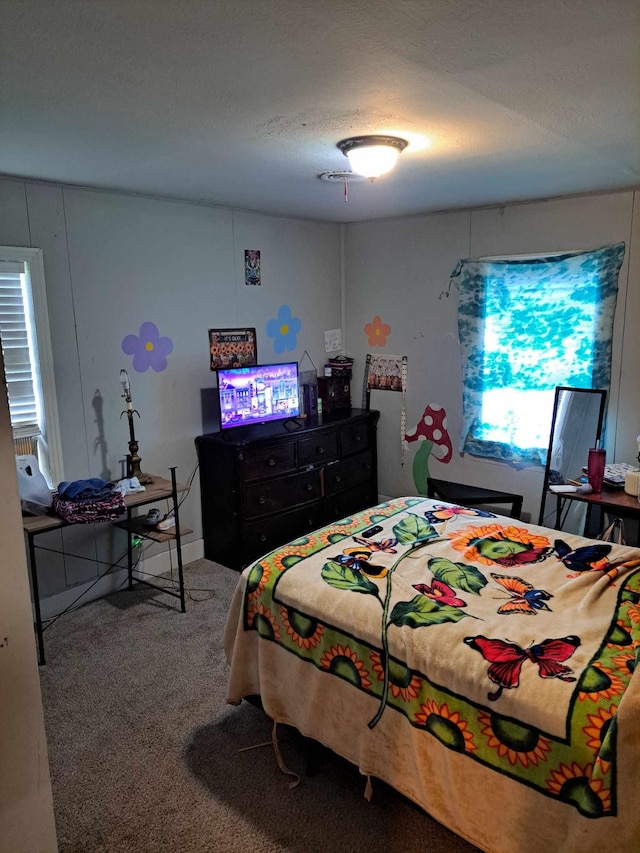 bedroom with carpet flooring and a textured ceiling