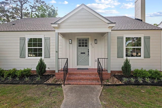 815 Central Dr, Beaumont, TX 77706 - view of front of house with roof with shingles, a chimney, and a front yard