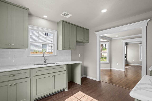 815 Central Dr, Beaumont, TX 77706 - kitchen with a sink, green cabinetry, decorative backsplash, dark wood-style flooring, and crown molding