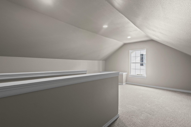 815 Central Dr, Beaumont, TX 77706 - additional living space with baseboards, light carpet, vaulted ceiling, a textured ceiling, and recessed lighting