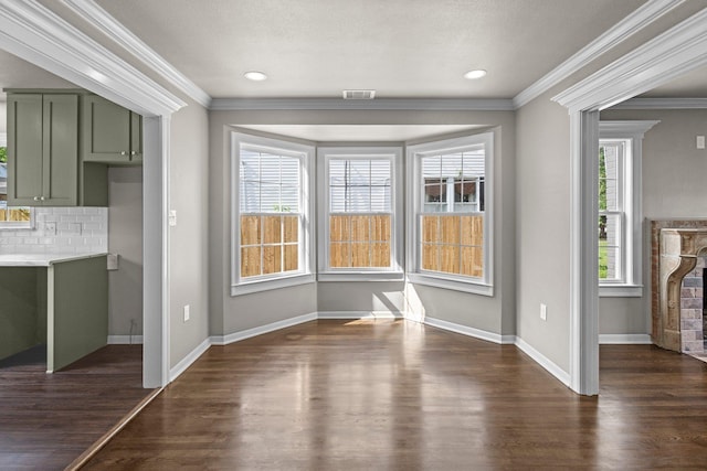 815 Central Dr, Beaumont, TX 77706 - unfurnished dining area featuring healthy amount of natural light, dark wood-style floors, crown molding, and baseboards