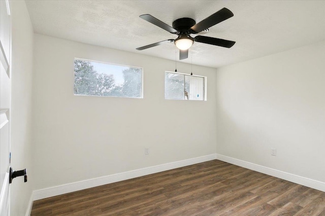 empty room featuring ceiling fan and dark hardwood / wood-style flooring