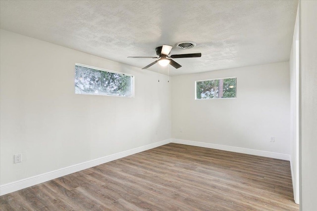 unfurnished room featuring a textured ceiling, hardwood / wood-style flooring, and ceiling fan