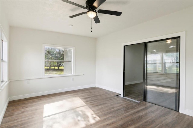 unfurnished room with ceiling fan and hardwood / wood-style flooring