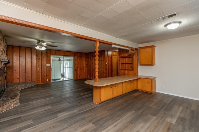 3012 Berry Ave, Groves, TX 77619 - kitchen featuring a peninsula, open floor plan, dark wood finished floors, ceiling fan, and wooden walls