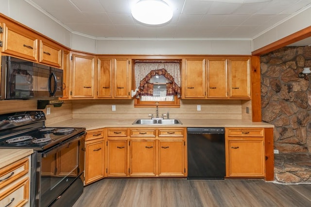 3012 Berry Ave, Groves, TX 77619 - kitchen with black appliances, light countertops, dark wood-type flooring, crown molding, and brown cabinets