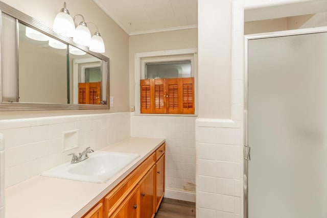 3012 Berry Ave, Groves, TX 77619 - full bathroom featuring ornamental molding, vanity, a stall shower, tile walls, and wainscoting